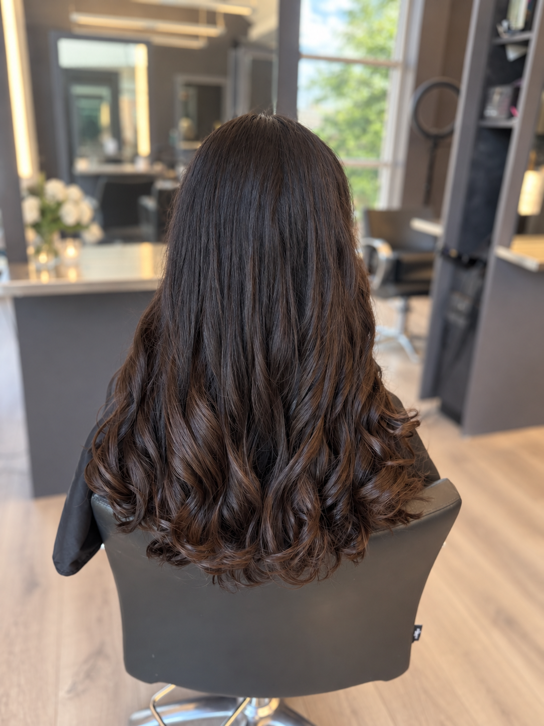 Long polished dark curls styled by Capuano Bridal