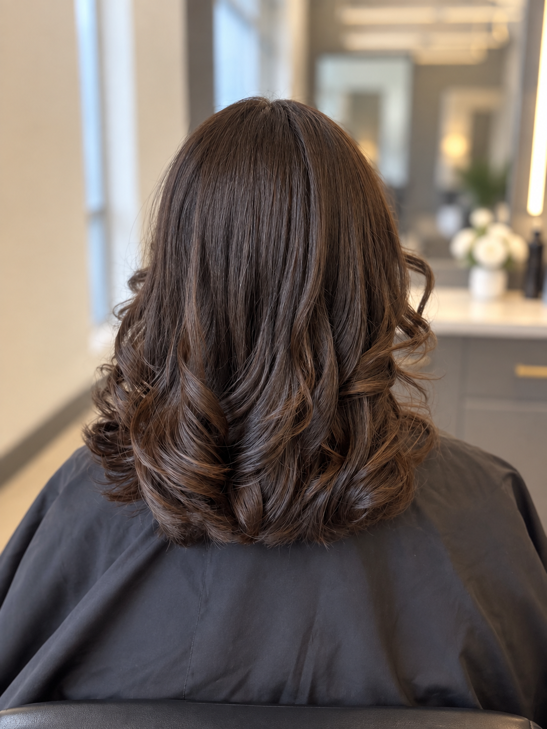 Glossy brunette curls styled by Capuano Bridal